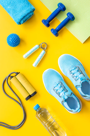 Sport fitness tolls flat lay with sneakers and dumbbells, top viewの写真素材