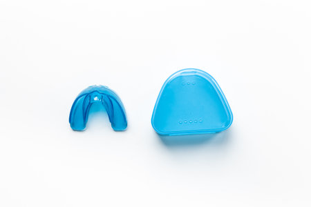 Orthodontic appliance for correction of teeth with a box on white background. Dental mouth guard.