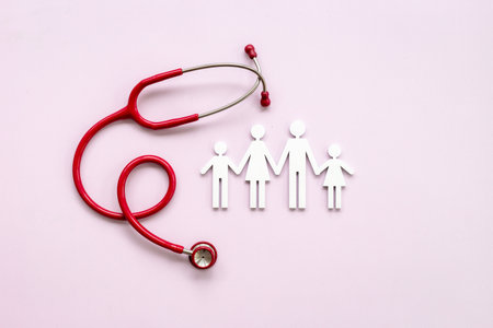 Family wooden figure with medical stethoscope - health care and insurance concept. top view.の写真素材