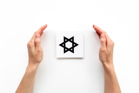 Hands holding Judaism David star symbol. World religious concept.