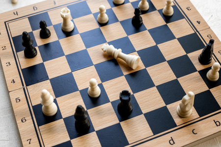 Checkmate. White king chess piece laying down on chessboard after checkmate.の写真素材