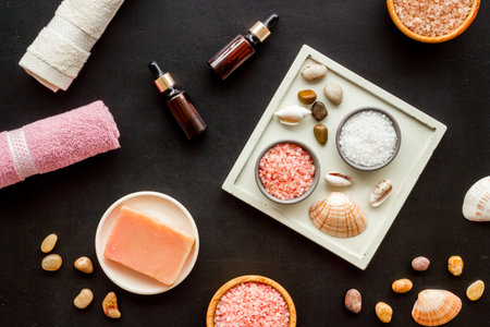 Essential oil in bottles and spa cosmetics with towels, top view. Beauty spa therapy cosmetics and wellness flat lay.の写真素材