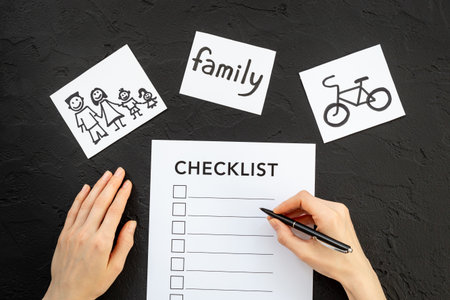 Hand writes in Checklist and many paper cards with hand drawing of different life activities, top...