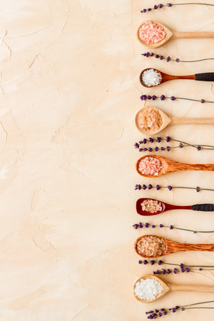 Spa treatment body care cosmetics - sea salt and scrubs in spoons, top view.の写真素材