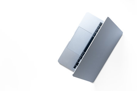 Silver laptop and mobile phone - high tech gadgets on white background, top view.の写真素材