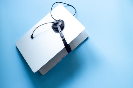 Headset and laptop top view. Customer support equipment at call center. Online conference. Online education concept.の写真素材