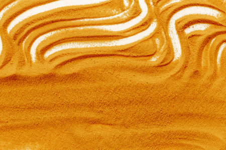 Lines and details of yellow sand texture background, close up top view. Abstract sand surface.