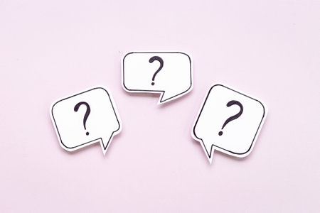 Question marks on speech bubbles, top view. Ask and answer concept