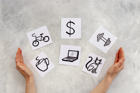 Hands with many paper cards with hand drawing of different life activities, top view. Time management concept. Life balance and planning conceptの写真素材