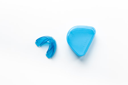 Orthodontic appliance for correction of teeth with a box on white background. Dental mouth guard.の写真素材