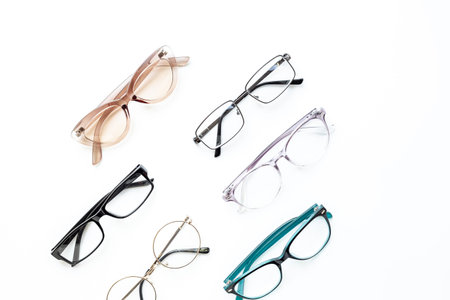 Many different styles of eyeglasses with lenses on white. Eye care and protection concept.