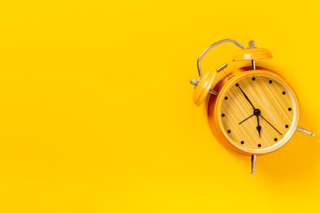 Vintage alarm clock with bells at seven o'clock. Morning routine. In time concept.の写真素材