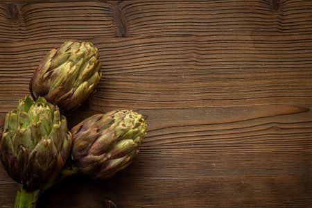 Top view of three whole head of purple artichokes. Vegetable ready to cook.の写真素材