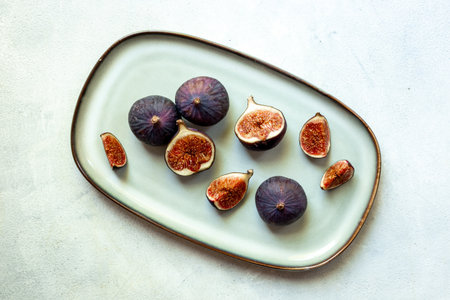 Fresh ripe figs on a plate top view on a gray backgroundの写真素材