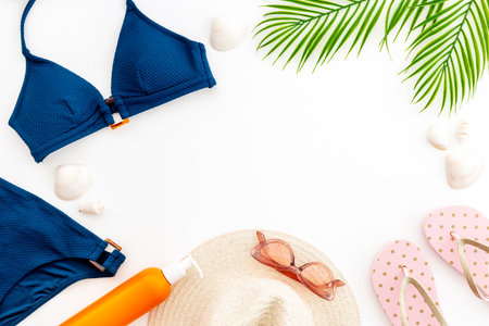 Bikini swimsuit with sunglasses and sunscreen - tropical flat layの写真素材