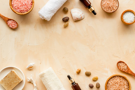 Essential oil in bottles and spa cosmetics with towels, top view. Beauty spa therapy cosmetics and wellness flat layの写真素材