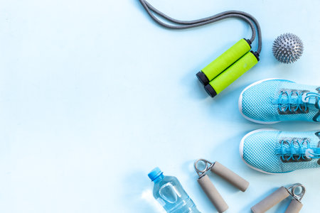 Sport fitness tolls flat lay with sneakers and dumbbells, top viewの写真素材