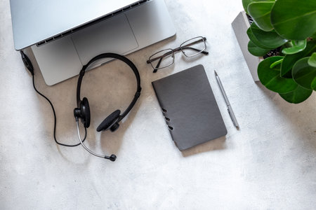 Headset and laptop top view. Customer support equipment at call center. Online conference. Online education conceptの写真素材