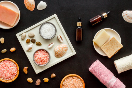 Essential oil in bottles and spa cosmetics with towels, top view. Beauty spa therapy cosmetics and wellness flat layの写真素材