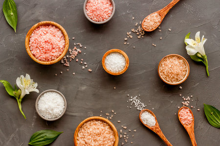 Beauty spa therapy cosmetics and wellness flat lay - sea salt in many bowls with flowers, top viewの写真素材
