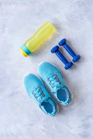 Top view of gym sports equipment with sneakers and dumbbells. Wellness conceptの写真素材