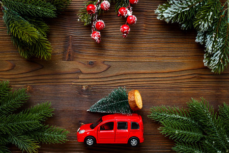 Festive New Year decoration and red toy car with Christmas tree on the roof.の写真素材