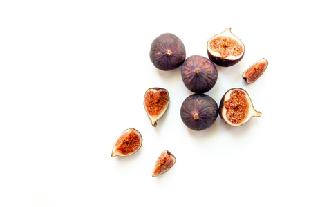 Purple ripe figs and slices top view on a white background.の写真素材