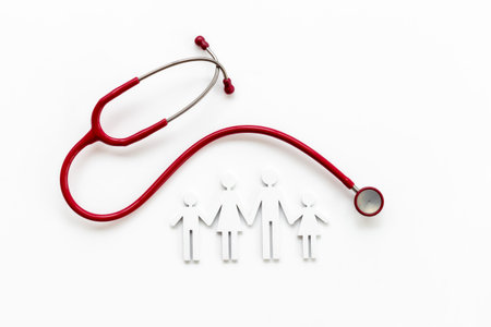 Family wooden figure with medical stethoscope - health care and insurance concept. top view.の写真素材