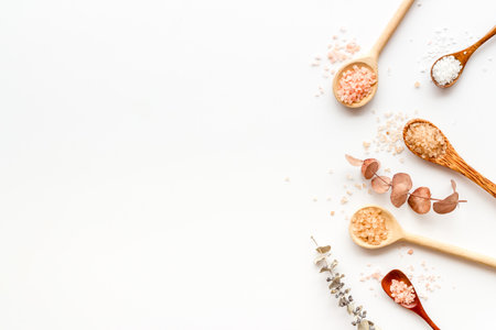 Spa flat lay with many spoons full of sea salt and scrubs, top view. Body care cosmetics.の写真素材