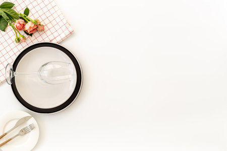 Festive table setting with empty plate and glass, cutlery and napkin, flat lay. Top view.の写真素材