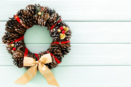 Christmas wreath made of tree bark and dry cones on the wall. New Year DIY decoration.の写真素材