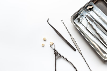 Many dental metal tools and teeth crows for implantation on white background. Professional Dentist desktop, top view.の写真素材
