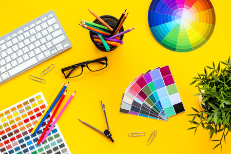 Color paint swatches and decorator or designer tools for work. Desktop flat lay, top view.の写真素材