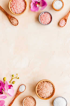 Beauty spa therapy cosmetics and wellness flat lay - sea salt in many bowls with flowers, top view.の写真素材