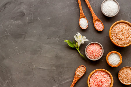 Spa treatment body care cosmetics - sea salt and scrubs in bowls, top view.の写真素材