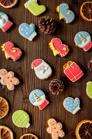 Set of different Christmas and New Year gingerbread cookies on dark wooden background, top view. Festive food concept.の写真素材