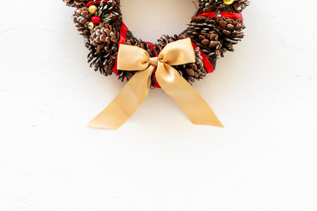 Christmas wreath made of tree bark and dry cones on the wall. New Year DIY decoration.の写真素材