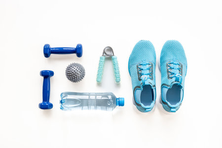 Flat lay of fitness sports equipment. Sneakers and dumbbells for gym. Wellness concept.の写真素材