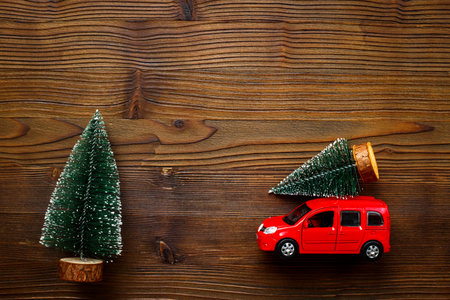 Festive New Year decoration and red toy car with Christmas tree on the roof.の写真素材