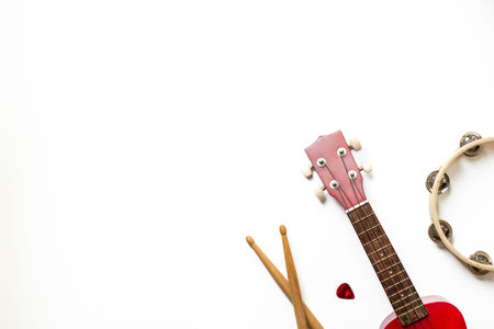 Musical instruments - small guitar and tambourine top view.