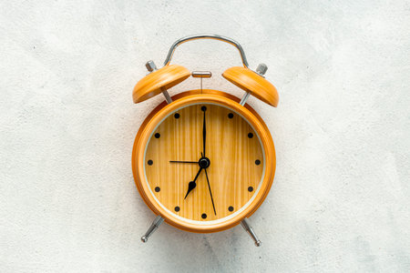 Vintage wooden alarm clock at seven o'clock. Morning routine. In time concept.