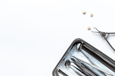 Many dental metal tools and teeth crows for implantation on white background. Professional Dentist...