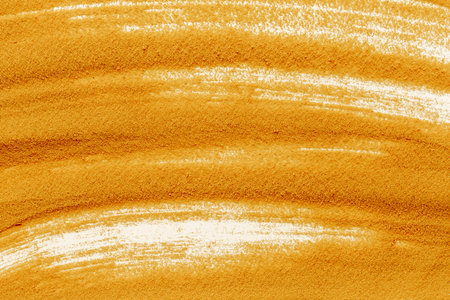 Yellow sand texture background, close up top view. Abstract sand surface.