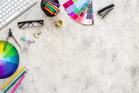 Color paint swatches and decorator or designer tools for work. Desktop flat lay, top view.