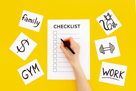 Hand writes in Checklist and many paper cards with hand drawing of different life activities, top...