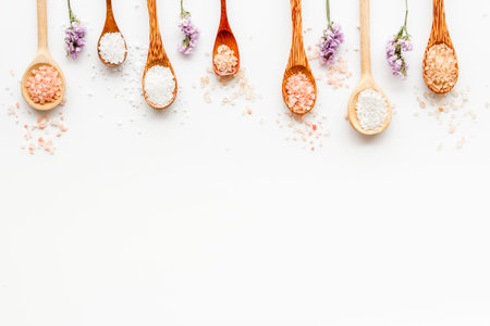 Spa treatment body care cosmetics - sea salt and scrubs in spoons, top view.の写真素材