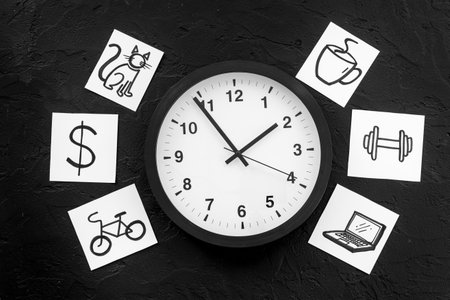 Wall clock and many paper cards with hand drawing of different life activities, top view. Time management concept. Life balance and planning conceptの写真素材