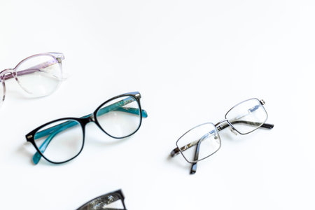 Many different styles of eyeglasses with lenses on white. Eye care and protection concept.