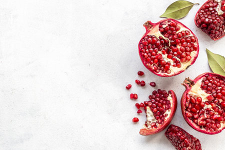 Top view of fresh ripe pomegranate with half and pieces ready for eating.の写真素材