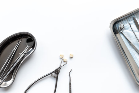 Many dental metal tools and teeth crows for implantation on white background. Professional Dentist desktop, top view.の写真素材